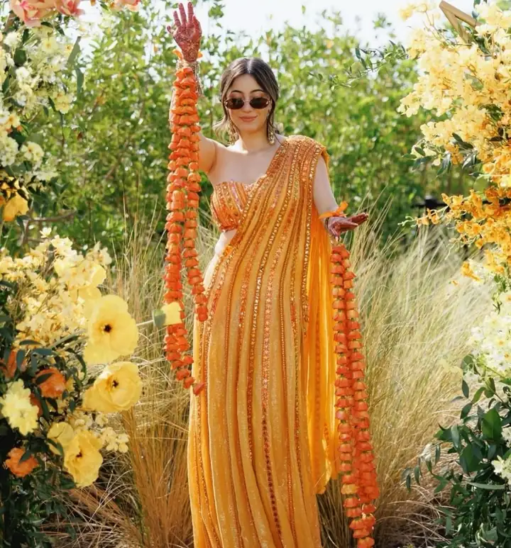 Haldi look in a yellow saree with marigold garlands